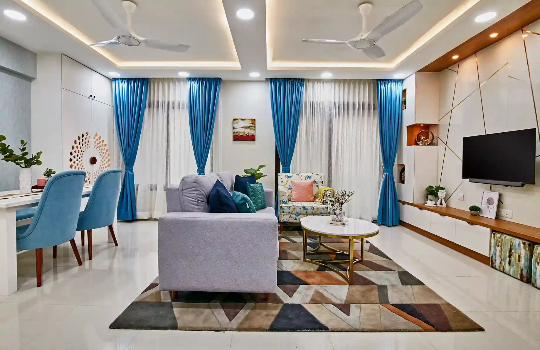 A modern living room Interior Design with a big TV unit in Bangalore by Interiosplash Interior Design Company