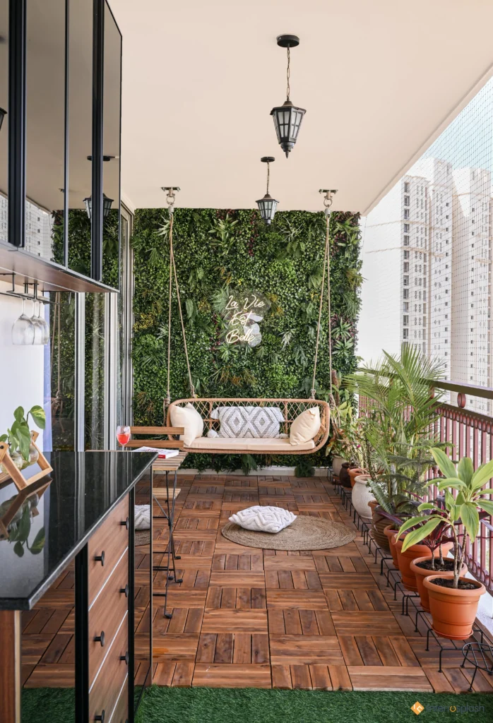 A perfect balcony interior design with an elegant swing, vertical garden, wooden flooring, and potted plants–ideal for urban living