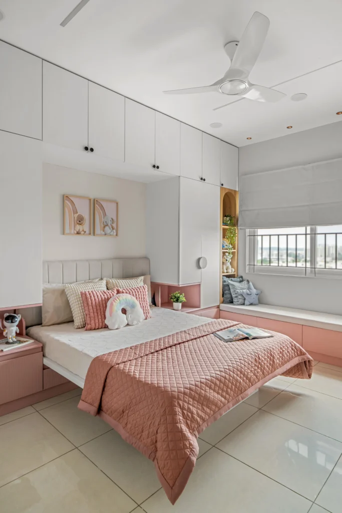 A wide angle view of a kids bedroom interior, where every element from upholstery of the bed to the storage cabinet and window, everything is personalized to resonate with the dream of a little champ residing here. The bed might look floating, it is convertible to transform this bedroom into a playroom for the kid.
